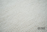 Ivory wool rug shown at full size on wood flooring