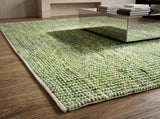 Cashew Loop — Green wool rug styled in a living room