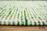 Cashew Loop — detail showing the make and finish of the Green wool rug