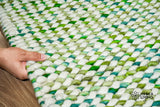 Cashew Loop — Green wool rug shown flat and in full on a plain white ground, detail crop of the centre (third pass)