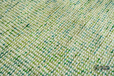 Cashew Loop — Green wool rug shown flat and in full on a plain white ground, seen from a three-quarter angle (fourth pass)