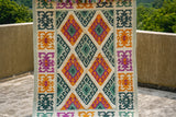 Green tribal wool rug under a coffee table