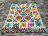 Full view of green Moroccan tribal rug on floor