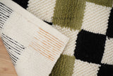 Checkered wool rug corner and edge detail