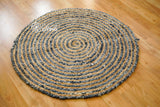 Full view of denim jute round rug on wood floor