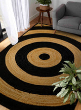 Black ring jute rug styled in a living room