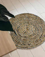 Round denim rug styled in a bohemian entryway