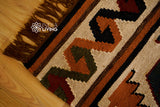 Southwestern Aztec kilim rug folded for shipping