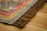 Close-up of light blue and pink tribal motif weave