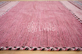 Overhead view of pink kilim rug