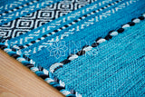 Teal blue kilim rug shown at an alternate angle