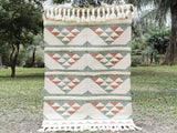 Pink blue kilim rug styled in a pastel living room