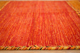 Orange kilim rug styled in bedroom