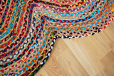 Multicolour rag rug placed beside a reading chair