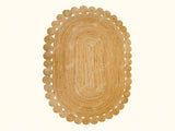 Natural jute oval rug laid flat showing braided texture
