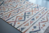 Ivory striped rug styled in a living room setting