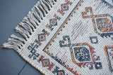 Ivory jute rug styled in a bedroom setting