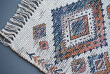 Off white jute rug corner detail showing Moroccan print