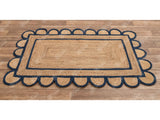 Navy jute rug styled in a bohemian living room