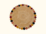 Round jute rug styled with a plant and chair nearby