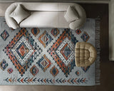 Off white jute rug styled in a bedroom