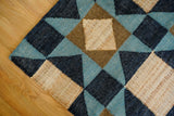 Blue abstract rug shown at an angle in room decor