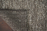 Close-up of chunky looped wool pile texture in charcoal brown