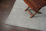 Chunky wool rug under a bed frame
