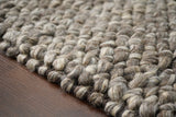 Charcoal brown wool rug in a bedroom setting