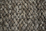 Charcoal brown wool rug corner detail showing weave