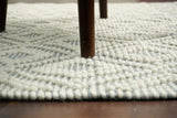 Diamond loop wool rug corner detail showing edge finish