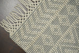Diamond loop wool rug in a bedroom setting
