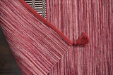 Pink kilim rug shown at an angle in room decor