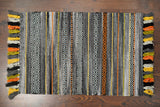 Braided edge detail of grey striped rug