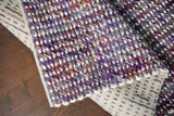 Purple wool rug styled in a living room
