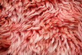 Pink shag rug styled in a bedroom setting