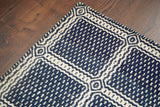 Blue wool rug styled in a bedroom