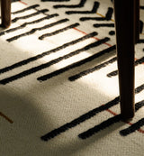 Ivory flatweave rug styled in a living room setting