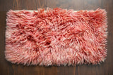 Pink shag wool rug full flat lay top view