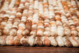 Brown wool rug styled in a living room