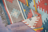 Vintage rug detail showing braided fringe edge