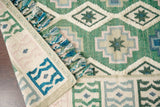 Sage green wool rug tassel fringe close-up
