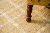 White striped jute rug styled in a living room