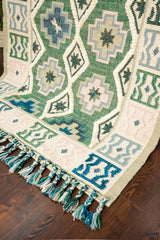 Green kilim rug tassel edge detail