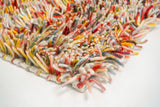 Multicoloured wool shag rug texture close-up