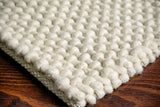 Ivory loop chunky wool rug styled in living room
