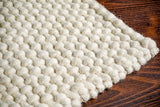 Ivory loop chunky wool rug texture close-up