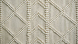 Abstract ivory chunky wool rug texture close-up