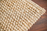 Full top-down view of beige wool rug