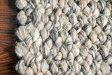 Close-up of cashew weave loop texture on grey wool rug